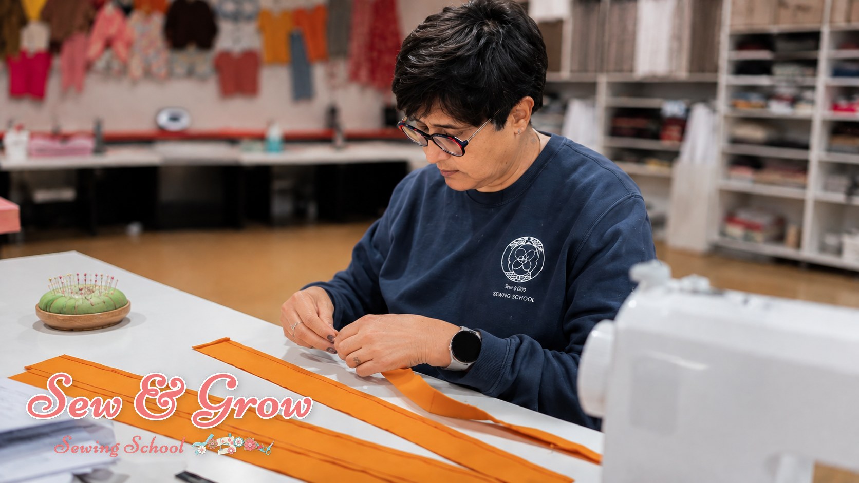 A proud adult beginner holding a garment they made
