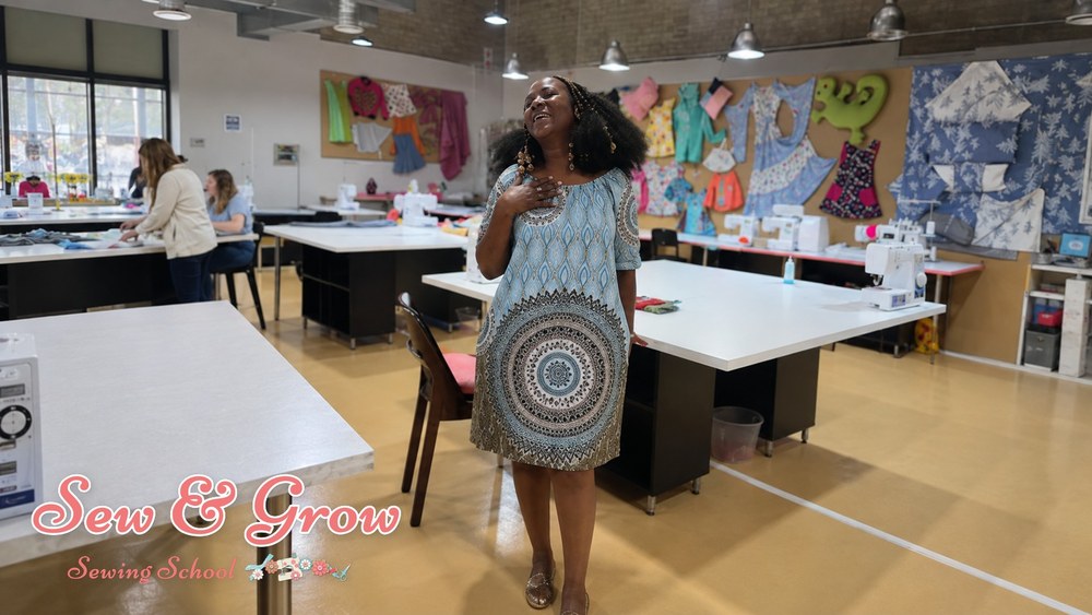 A delighted student standing proudly in the studio